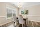 Charming dining area with wood table and chairs, and a wall art piece at 622 Chronicle Dr, Cary, NC 27513