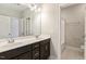 Bathroom with double vanity, dark brown cabinets, and shower/tub combo at 622 Chronicle Dr, Cary, NC 27513