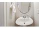 Small powder room with pedestal sink and oval mirror at 622 Chronicle Dr, Cary, NC 27513