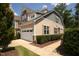 Tan and gray two-story townhome with a two-car garage and manicured landscaping at 622 Chronicle Dr, Cary, NC 27513