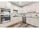 Well-equipped kitchen featuring white cabinets, double oven, and gas cooktop at 622 Chronicle Dr, Cary, NC 27513