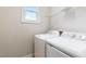 Laundry room with washer, dryer, and shelving at 622 Chronicle Dr, Cary, NC 27513