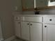 Bathroom vanity with white cabinets, black hardware, and a white countertop at 952 Olive Branch Dr, Smithfield, NC 27577