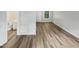 Bright living room with wood-look floors and access to bathroom and exterior at 2146 Charles St # 9, Durham, NC 27707
