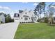 Two story white brick house with driveway at 2506 Silas Peak Ln, Apex, NC 27523