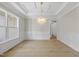 Formal dining room with hardwood floors, chandelier, and wainscoting at 2506 Silas Peak Ln, Apex, NC 27523