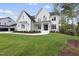 Two-story white brick home with a front yard and landscaping at 2506 Silas Peak Ln, Apex, NC 27523