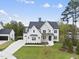 White farmhouse style home with a large grassy yard at 2506 Silas Peak Ln, Apex, NC 27523