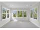 Bright bedroom with multiple windows showcasing a treetop view at 2506 Silas Peak Ln, Apex, NC 27523