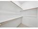 Spacious closet with white shelves and wooden hanging rods at 2506 Silas Peak Ln, Apex, NC 27523