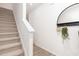Carpeted staircase with white railing and walls at 2833 Egert Dr, Haw River, NC 27258