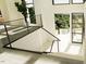 Modern glass and metal staircase with light wood flooring at 10397 Holt, Chapel Hill, NC 27517