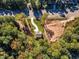 Aerial view of a house nestled in a wooded area, with nearby roads at 900 Sw Maynard Rd, Cary, NC 27511