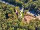 An aerial view of a house next to an empty lot in a wooded area at 900 Sw Maynard Rd, Cary, NC 27511