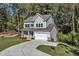 Two-story house with gray siding, stone accents, and a two-car garage at 900 Sw Maynard Rd, Cary, NC 27511