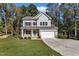 Two-story house with gray siding, stone accents, and a two-car garage at 900 Sw Maynard Rd, Cary, NC 27511