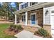 Stone front porch with blue door and white columns at 900 Sw Maynard Rd, Cary, NC 27511