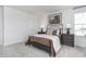 Spacious bedroom with dark brown bed frame and neutral colored bedding at 1713 Post Oak Dr, Haw River, NC 27258