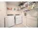 Laundry room with washer, dryer, and ample shelving at 312 Sustainable Way, Raleigh, NC 27610