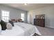 Bright main bedroom with king-size bed and large dresser at 245 Beacon Dr, Pittsboro, NC 27312