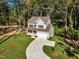 Two-story house on a wooded lot with a curved driveway at 900 Sw Maynard Rd, Cary, NC 27511