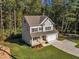 Two-story house on a wooded lot with a long driveway at 900 Sw Maynard Rd, Cary, NC 27511