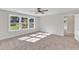 Spacious bedroom with large windows, ceiling fan, and carpeted floors at 900 Sw Maynard Rd, Cary, NC 27511