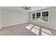Bedroom with large windows, ceiling fan, and carpeted floors at 900 Sw Maynard Rd, Cary, NC 27511