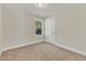 Bright bedroom with carpeted floor, neutral walls, and a window offering natural light at 900 Sw Maynard Rd, Cary, NC 27511