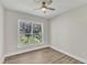 Bright bedroom with a large window, ceiling fan, and hardwood floors at 900 Sw Maynard Rd, Cary, NC 27511