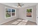Bedroom with large windows, carpet and ceiling fan at 900 Sw Maynard Rd, Cary, NC 27511