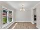 Spacious dining room with hardwood floors, large window, and chandelier at 900 Sw Maynard Rd, Cary, NC 27511