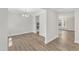Bright dining room with hardwood floors and a chandelier, open to kitchen at 900 Sw Maynard Rd, Cary, NC 27511