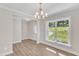 Bright dining room with hardwood floors, chandelier, and view to entryway at 900 Sw Maynard Rd, Cary, NC 27511