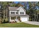 Two-story house with gray siding, stone accents, and a two-car garage at 900 Sw Maynard Rd, Cary, NC 27511