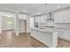 Modern kitchen with white cabinets, granite countertops, and stainless steel appliances at 900 Sw Maynard Rd, Cary, NC 27511
