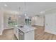 Open concept kitchen with island, stainless steel appliances, and hardwood floors at 900 Sw Maynard Rd, Cary, NC 27511