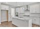 Modern kitchen with white cabinets, granite countertops, and stainless steel appliances at 900 Sw Maynard Rd, Cary, NC 27511