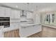 Modern kitchen with white cabinets, granite island, and stainless steel appliances at 900 Sw Maynard Rd, Cary, NC 27511