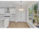 Bright kitchen with white cabinets, granite countertops, and large windows at 900 Sw Maynard Rd, Cary, NC 27511