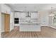 Modern kitchen with white cabinets, granite countertops, and stainless steel appliances at 900 Sw Maynard Rd, Cary, NC 27511