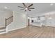 Open concept living room with hardwood floors and view into kitchen at 900 Sw Maynard Rd, Cary, NC 27511