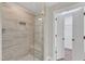 Walk-in shower with glass enclosure and tile surround at 900 Sw Maynard Rd, Cary, NC 27511