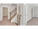 Elegant staircase with dark wood railings and neutral carpeting at 900 Sw Maynard Rd, Cary, NC 27511