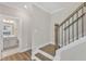 Modern staircase with dark wood railing and white risers at 900 Sw Maynard Rd, Cary, NC 27511