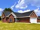 Brick ranch home with two-car garage and green lawn at 3701 Greystone Dr, Rocky Mount, NC 27804