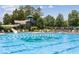 Community pool with waterslide and plenty of lounge chairs at 11549 Helmond Way # 102, Raleigh, NC 27617