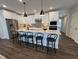 Modern kitchen with an island and stainless steel appliances at 11549 Helmond Way # 102, Raleigh, NC 27617