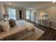 King-size bed in a well-lit bedroom with an ensuite bathroom at 11549 Helmond Way # 102, Raleigh, NC 27617