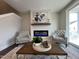 Cozy living room features a modern fireplace and comfortable armchairs at 11549 Helmond Way # 102, Raleigh, NC 27617